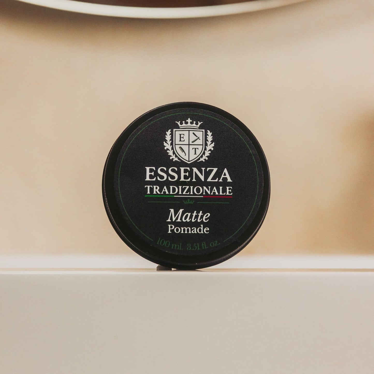 Essezna Tradizionale Matte Pomade container on a beige background