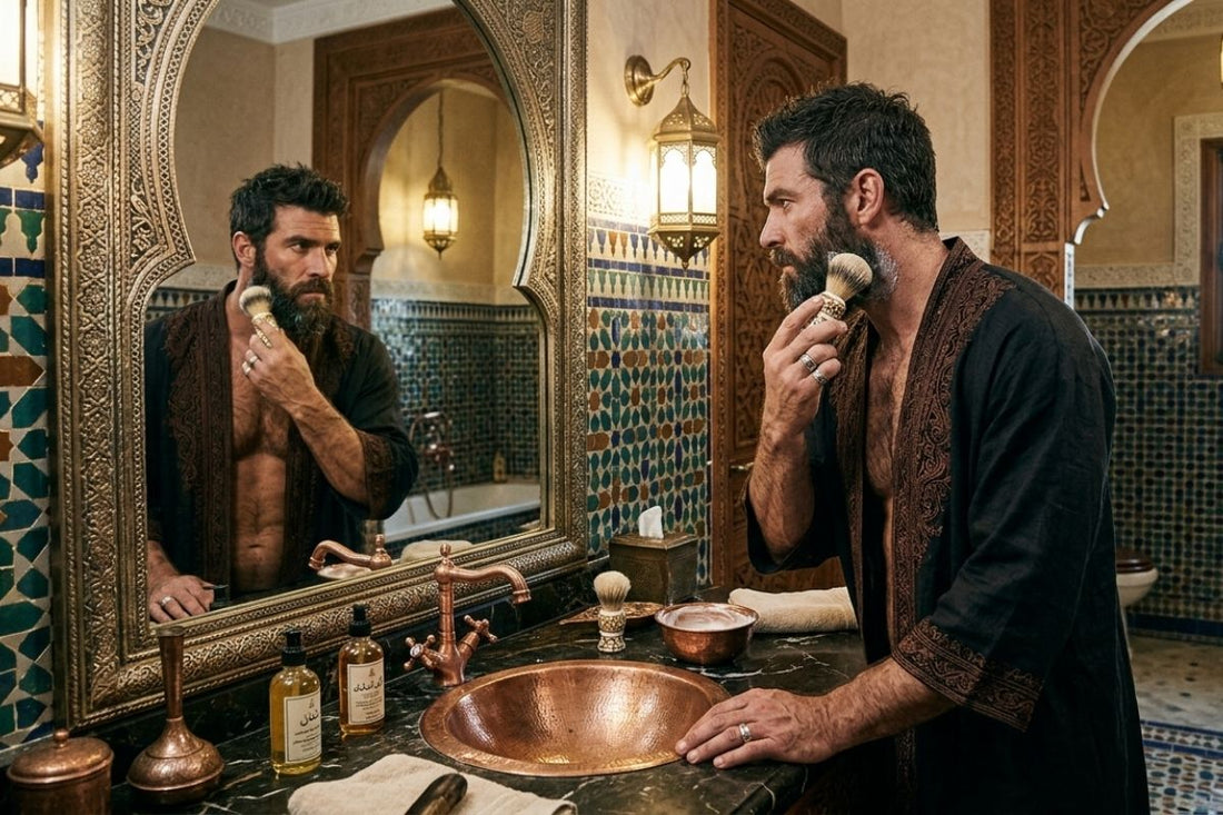 Well-groomed man shaving his beard in an elegant Mediterranean-style bathroom with classic grooming tools