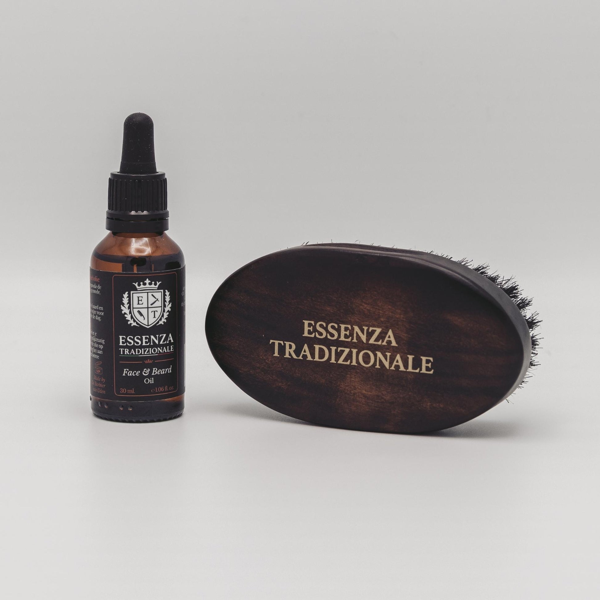 Bottle and brush with 'Essenza Tradizionale' branding on a gray background