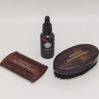 Set of wooden grooming tools with a bottle labeled 'Essenza Tradizionale' on a white background