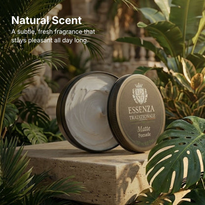 Two containers of Esseza Tradizionale Matte Pomade on a stone surface with green foliage in the background.
