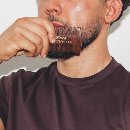 closeup of model brushing hair with essenza tradizionale wooden beard comb