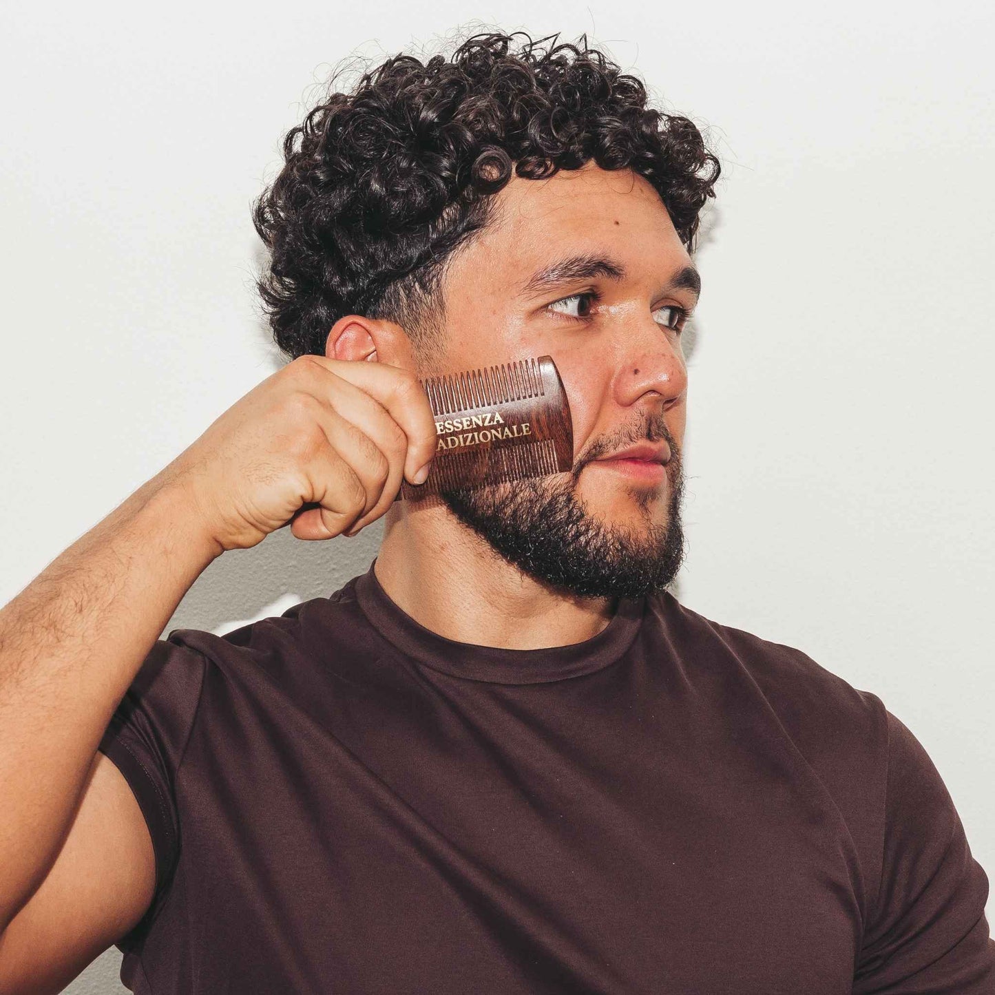 Handsome man Holding beard comb by essenza tradizionale