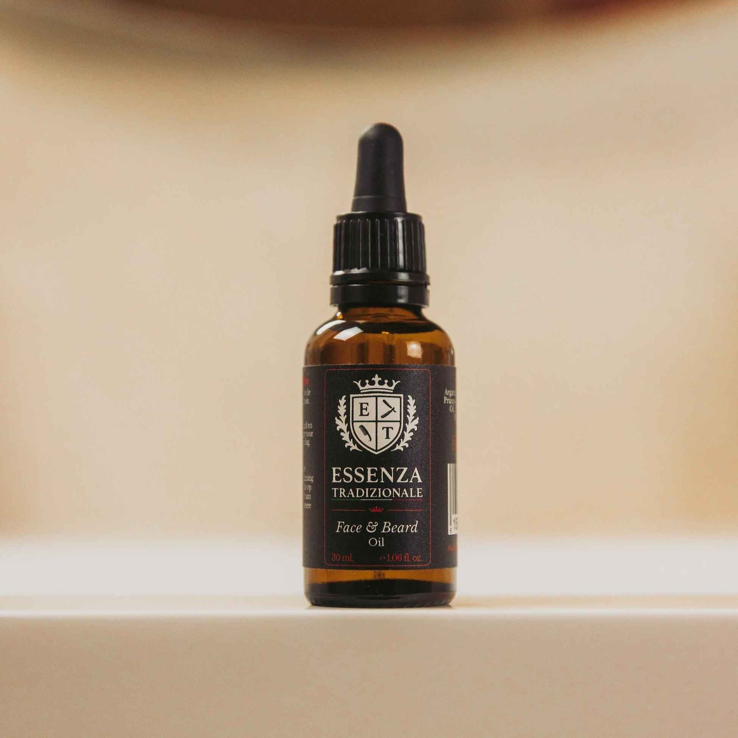 Bottle of Essenza Tradizionale face and beard oil on a beige background